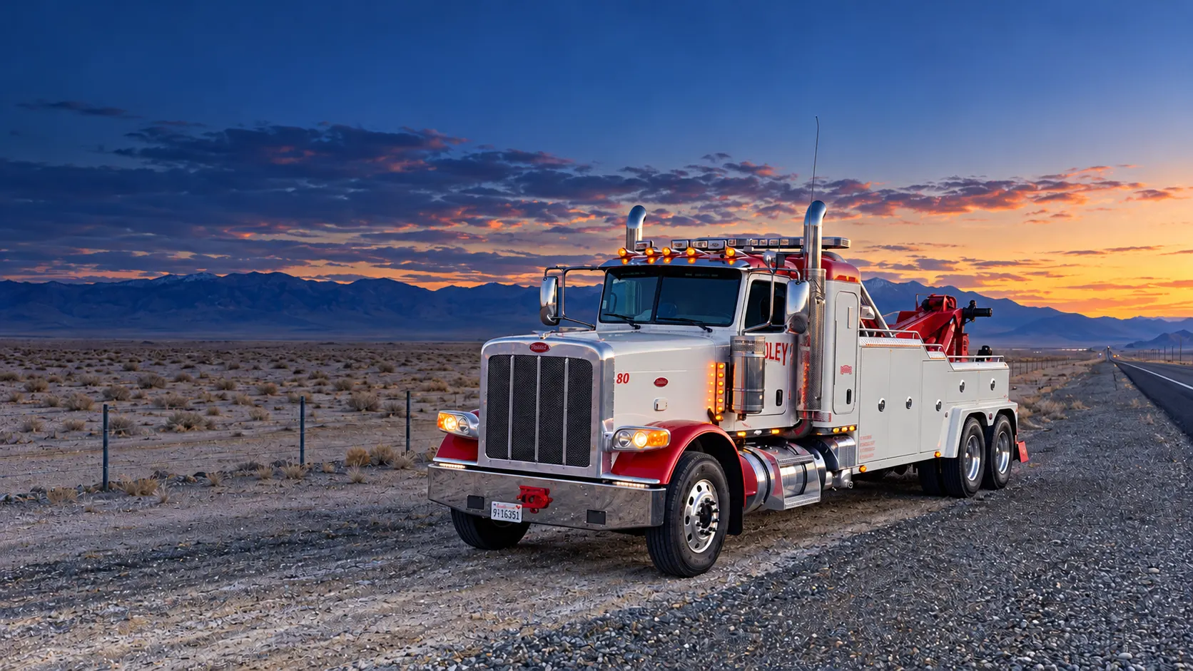 Hadley’s red and white heavy wrecker beside a desert highway at dusk; AI-enhanced concept based on Hadley’s fleet photograph
